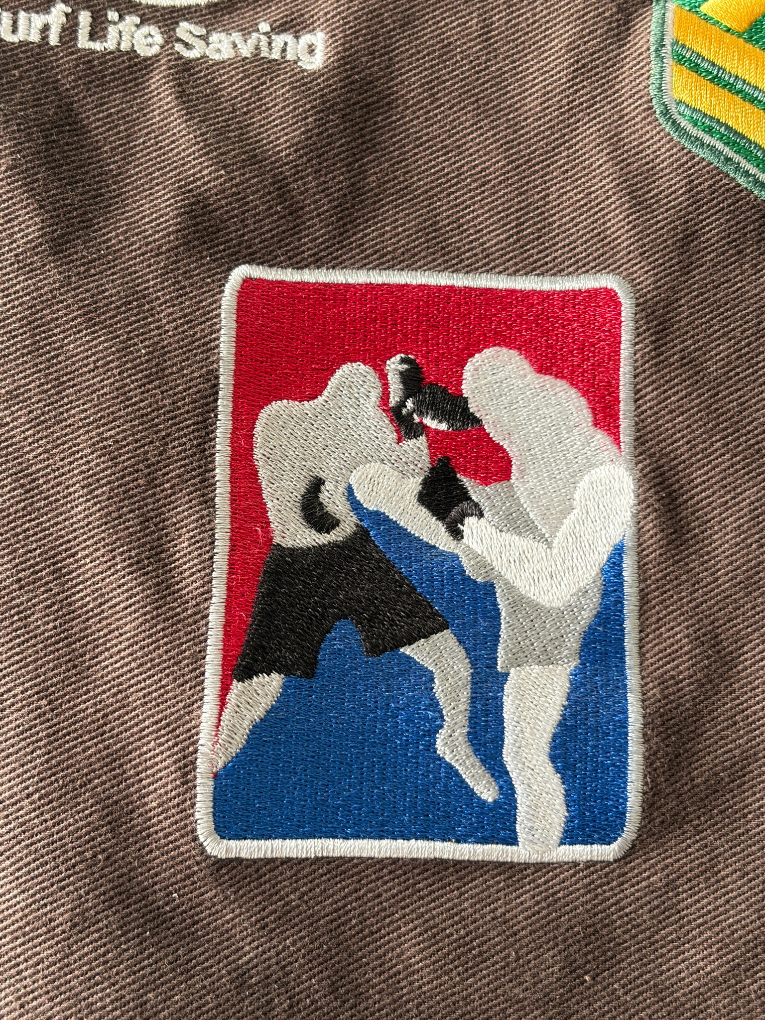 Detailed martial arts patch embroidered on brown fabric