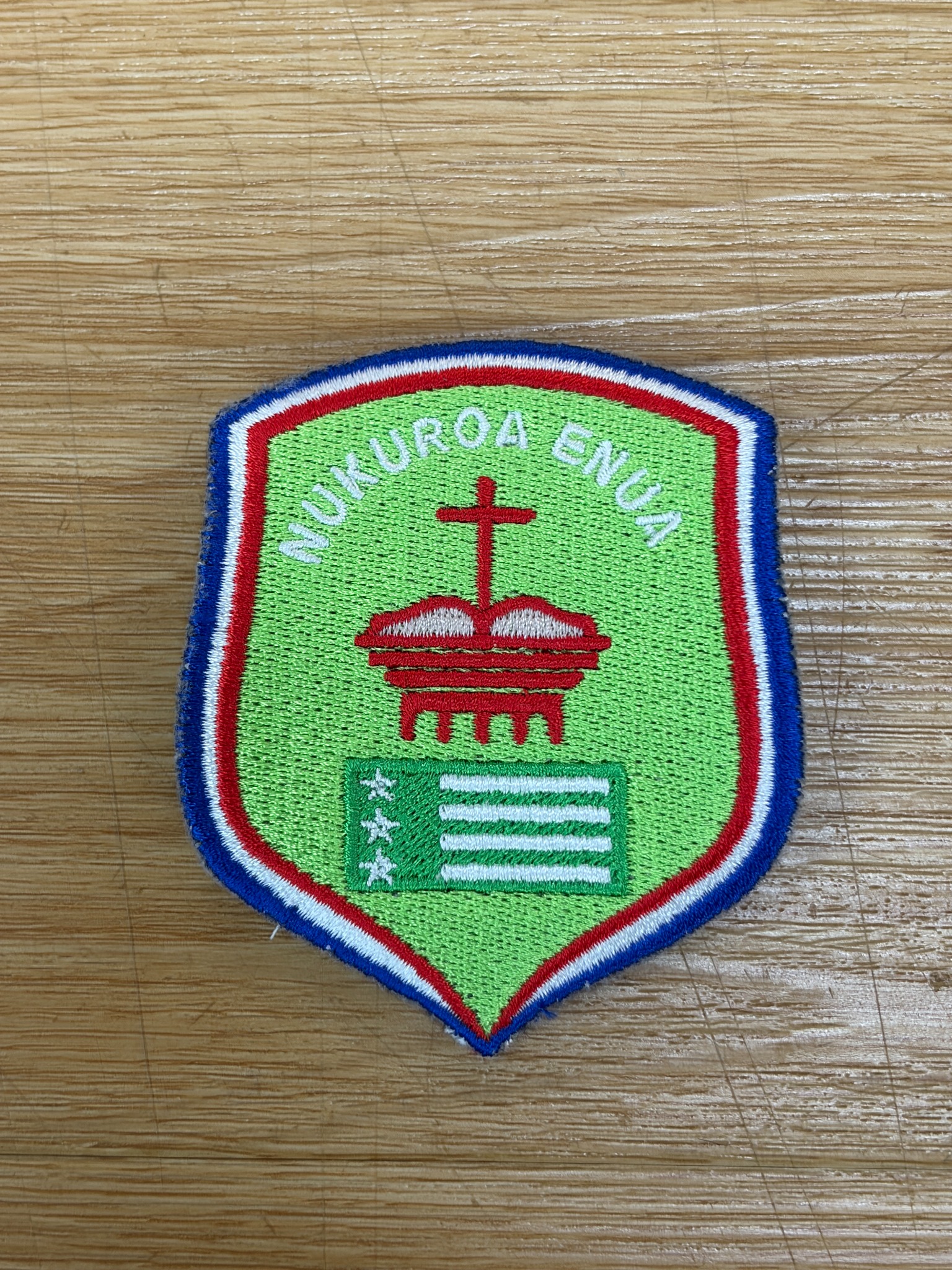 Custom green, red and blue shield-shaped embroidery patch